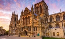 A stunning photo of York Minister, a Gothic cathedral in York, England. The image highlights the cathedral's impressive architecture and its proximity to Phone Doctor, a nearby mobile phone repair shop.